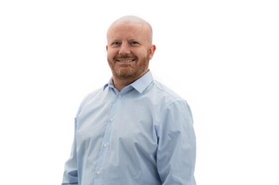 Lee Martyniak smiling in professional headshot