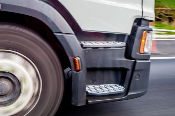 Lorry wheel driving along road
