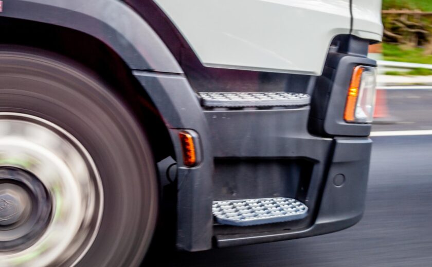 Lorry wheel driving along road