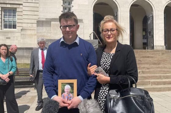 Mark and Stephanie outside court holding photograph