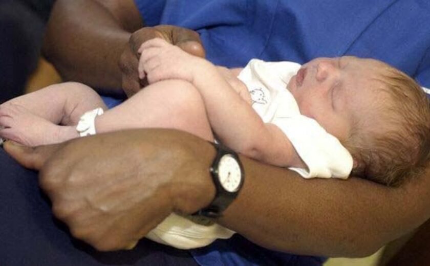 Midwife caring for newborn baby in hospital