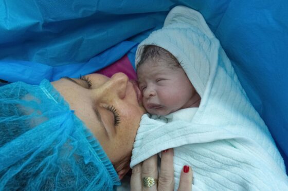 Mother holding newborn after birth