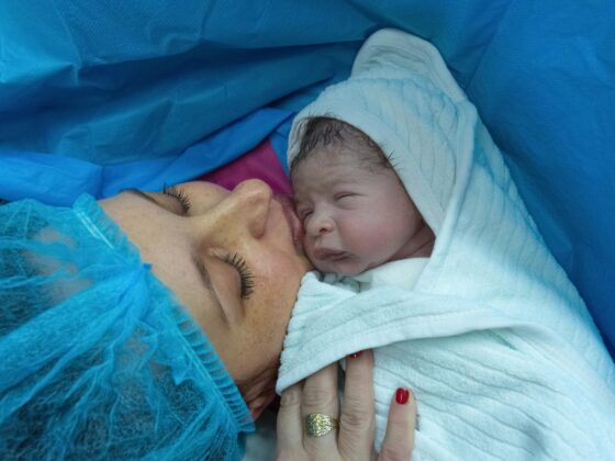 Mother holding newborn after birth