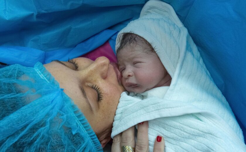 Mother holding newborn after birth