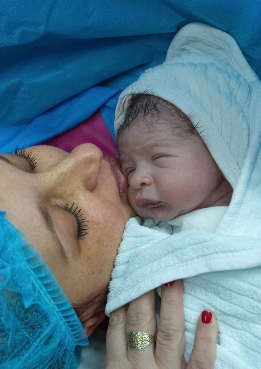 Mother holding newborn after birth