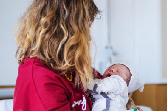 Mother holding newborn baby in hospital