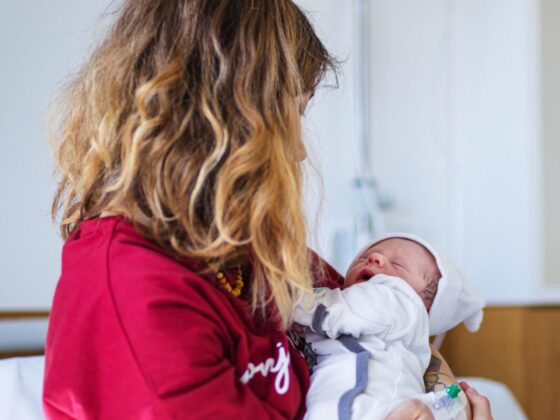 Mother holding newborn baby in hospital
