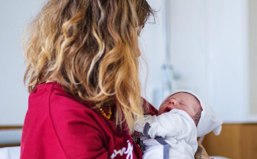 Mother holding newborn baby in hospital