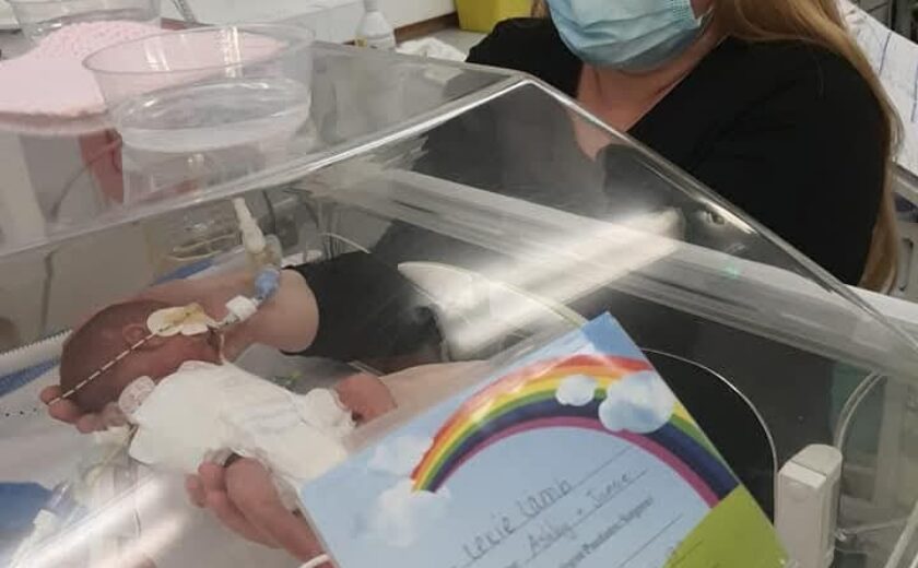 Mother visiting newborn baby in incubator
