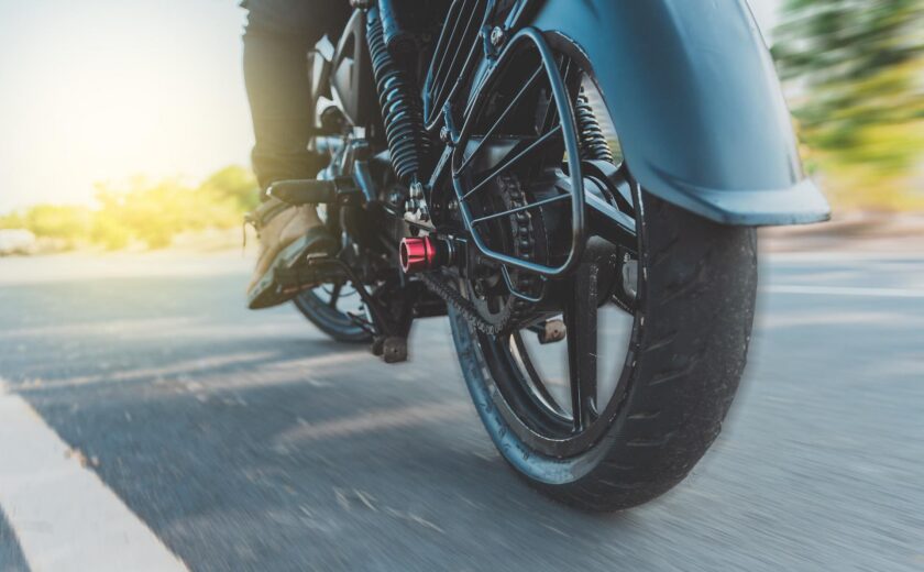 Motorcycle wheel moving along road