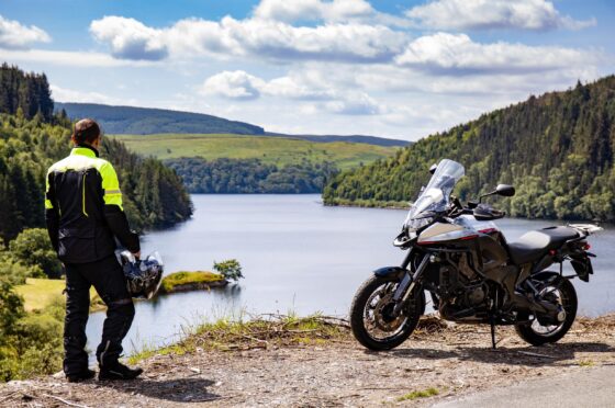 Motorcyclist looking over lake