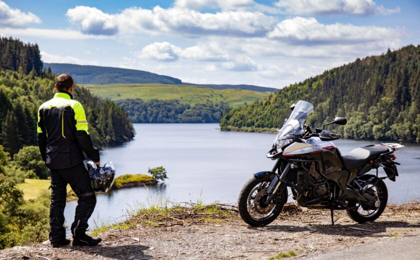 Motorcyclist looking over lake