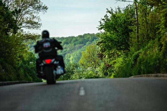 Motorcyclist riding along country road