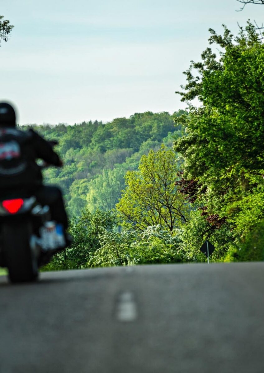 Motorcyclist riding along country road