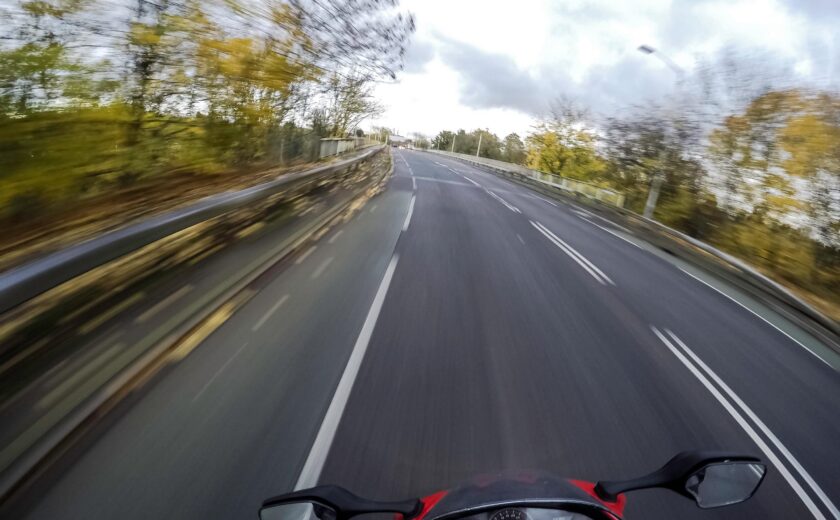 Motorcyclist riding along open road