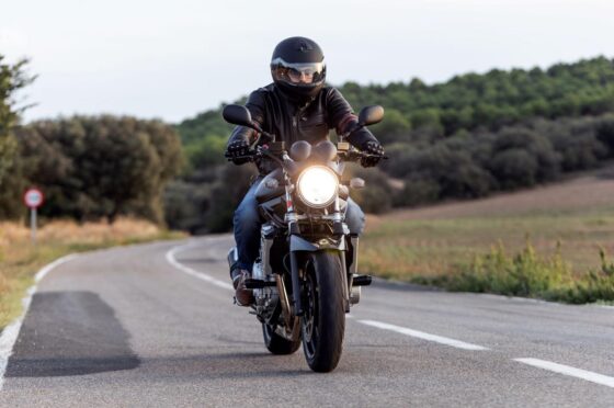 Motorcyclist riding on rural road