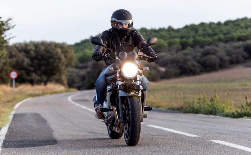Motorcyclist riding on rural road
