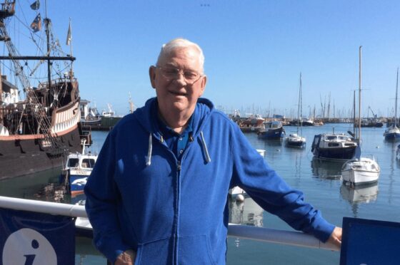 Mr Binning standing beside marina