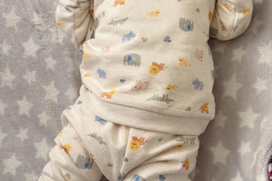 Newborn baby lying on blanket