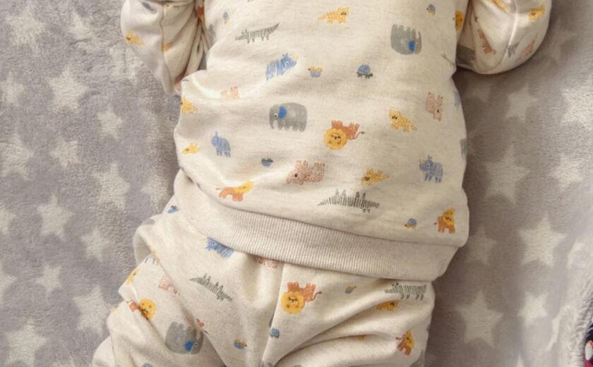 Newborn baby lying on blanket