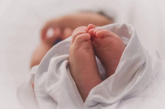 Newborn baby's feet wrapped in blanket