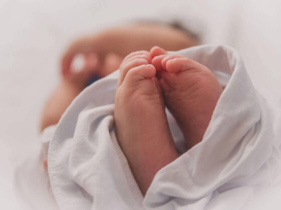 Newborn baby's feet wrapped in blanket