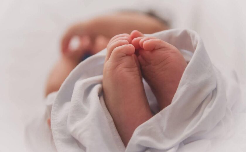 Newborn baby's feet wrapped in blanket