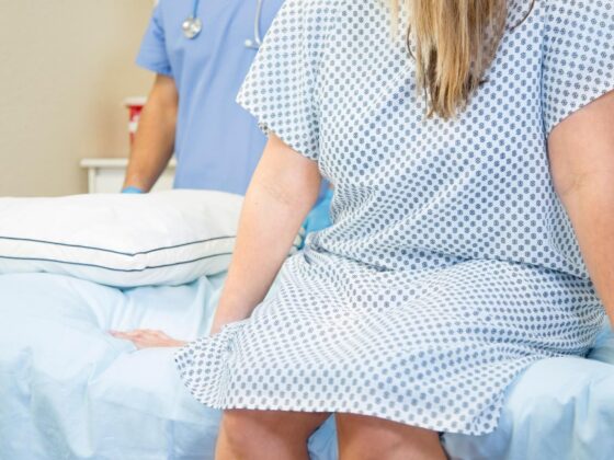 Patient sitting on hospital bed