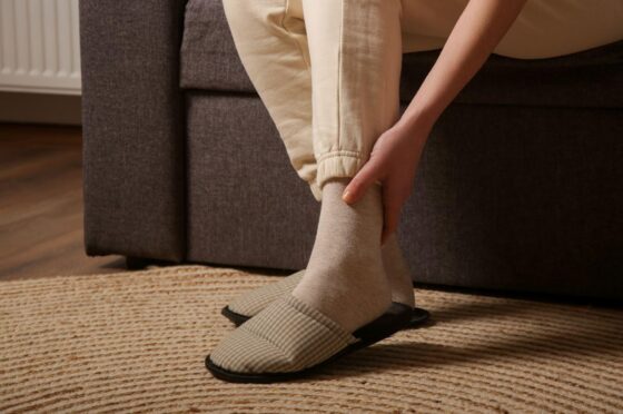 Person holding ankle after fall at home