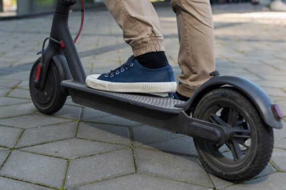 Person riding electric scooter on pavement