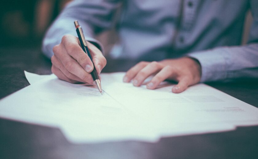 Person signing legal paperwork