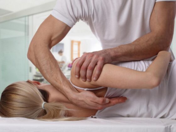 Physiotherapist stretching child's arm