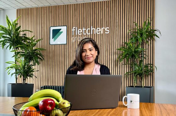 Pooja seated at Fletchers reception desk