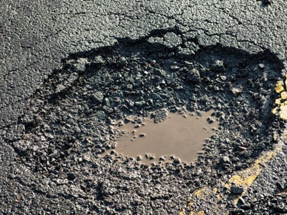 Pothole in damaged road surface