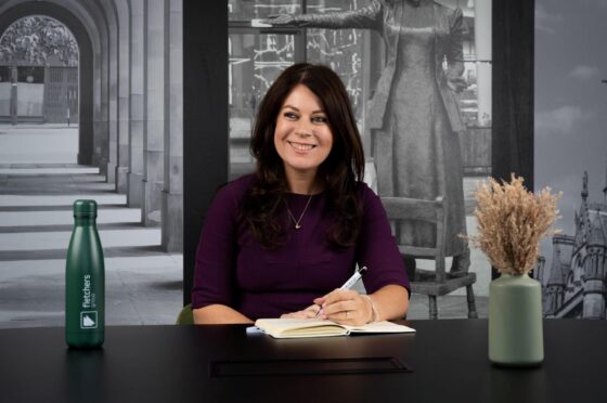 Sarah Samuels writing at desk