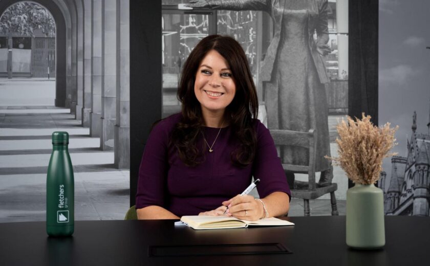 Sarah Samuels writing at desk