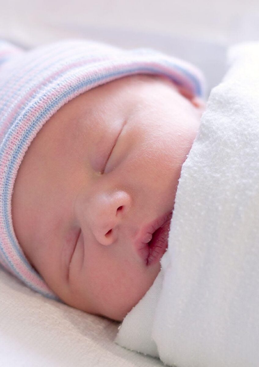 Sleeping newborn wrapped in blanket
