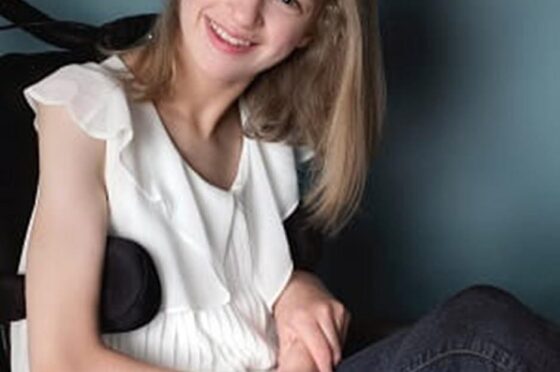 Smiling young woman seated in wheelchair