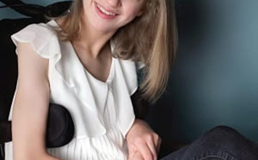 Smiling young woman seated in wheelchair