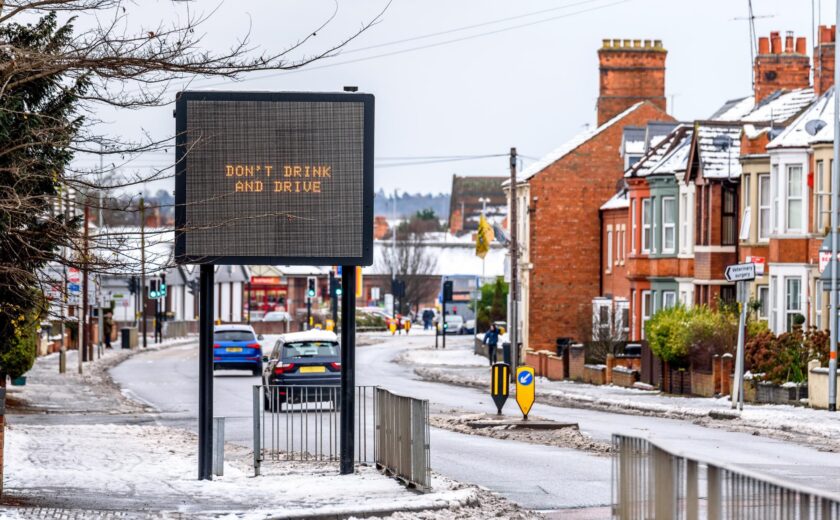 Snowy road with drink-drive warning sign