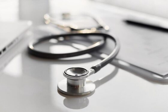 Stethoscope and laptop on medical desk