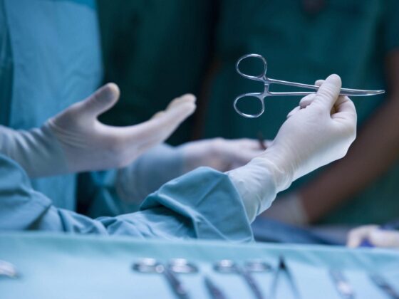 Surgeon holding forceps during operation
