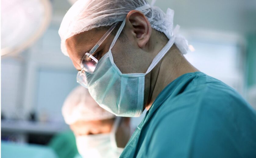 Surgeon wearing mask in operating theatre