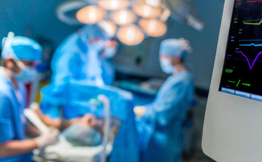 Surgeons operating in hospital theatre
