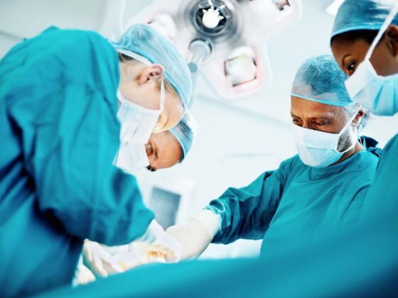 Surgeons operating in theatre