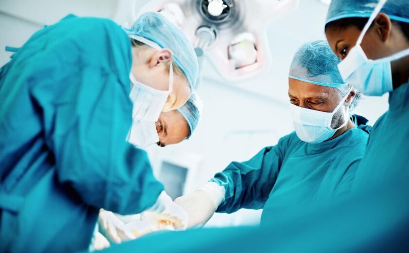 Surgeons operating in theatre