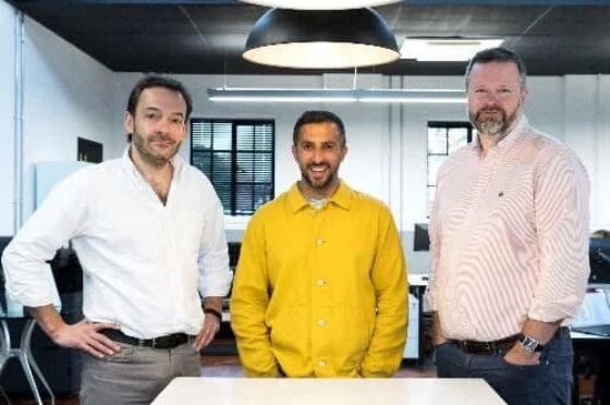 Three colleagues standing in office