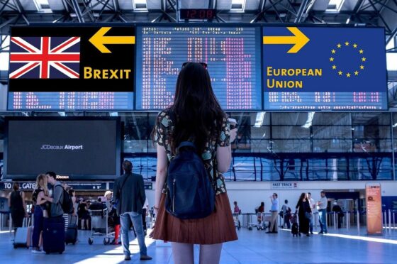 Traveller at airport under Brexit direction signs