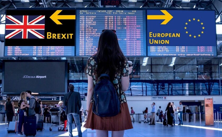 Traveller at airport under Brexit direction signs