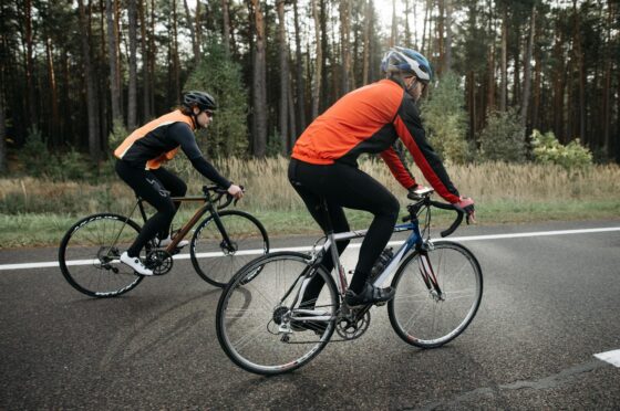 Two cyclists riding on road